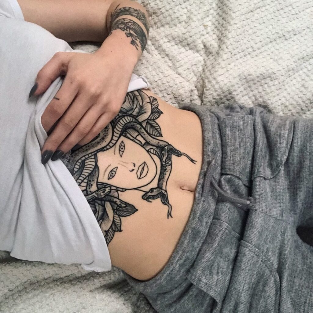 Uma imagem que ilustra uma tatuagem de medusa na barriga.